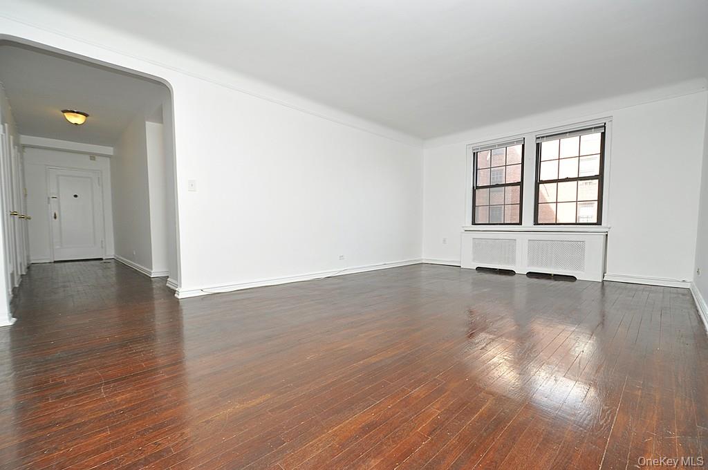 180 Garth Road, Unit 4F Scarsdale, NY 10583 - Photo 9 of 39 The large living room has hardwood floors, overlooks the manicured courtyard and opens to the dining room. The living room is approx. 19'-9" x 12'7".