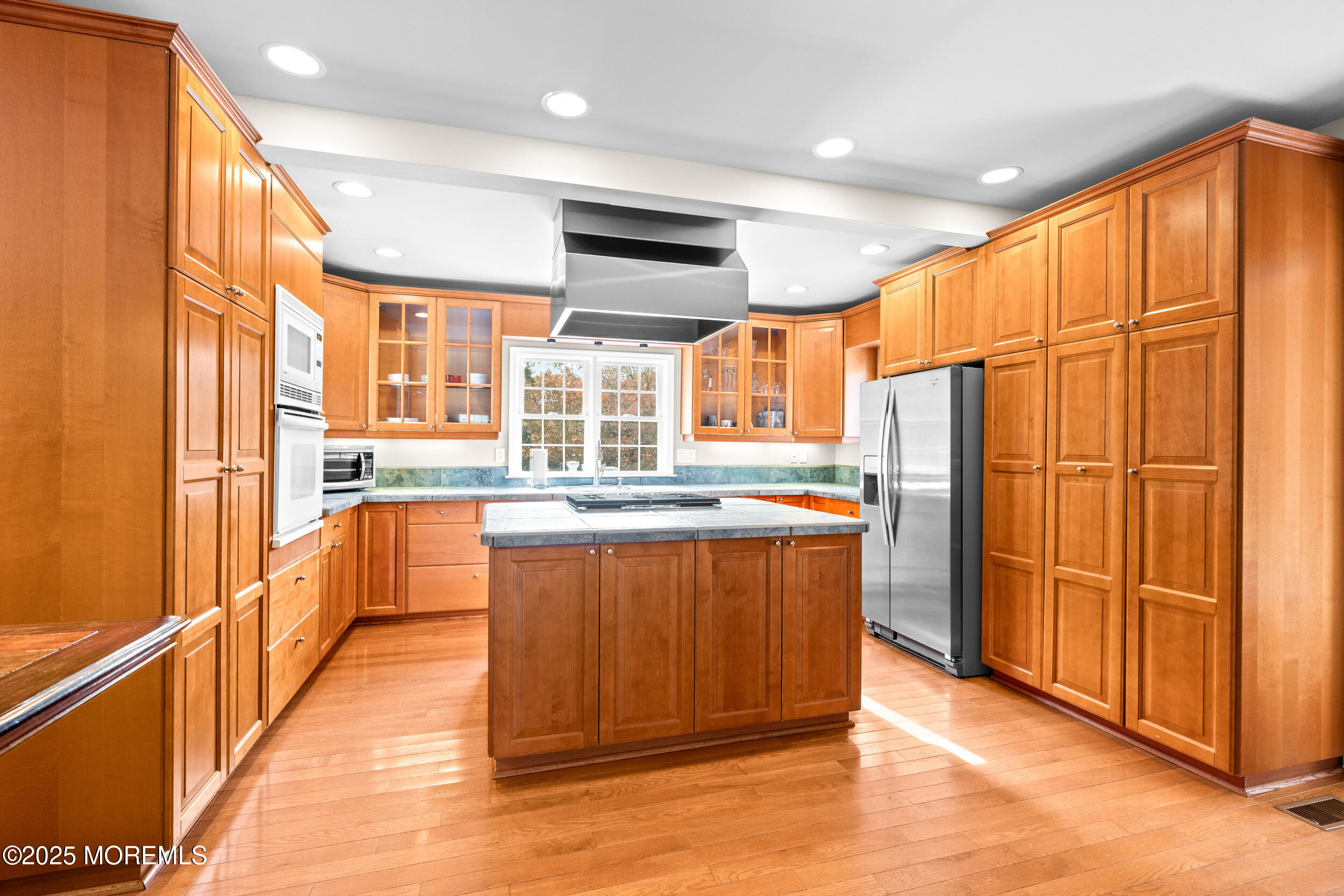 603 West Farms Road Howell, NJ 07731 - Photo 12 of 38 a kitchen with stainless steel appliances granite countertop a refrigerator a sink dishwasher and wooden cabinets with wooden floor