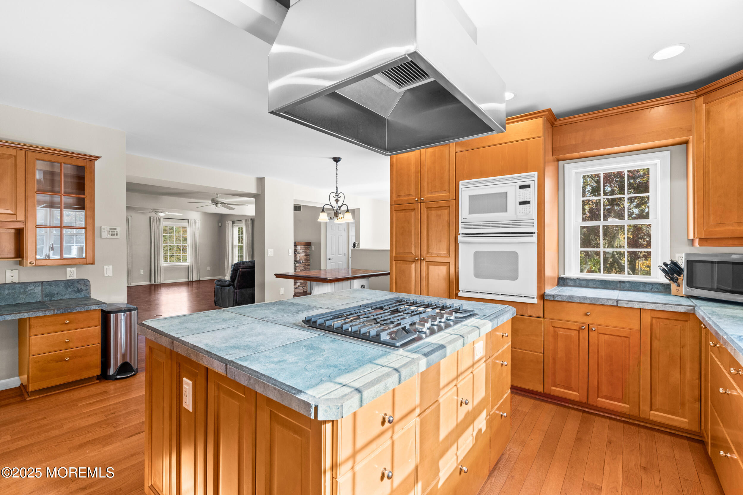 603 West Farms Road Howell, NJ 07731 - Photo 14 of 38 a view of kitchen island a sink wooden floor dining table and chairs