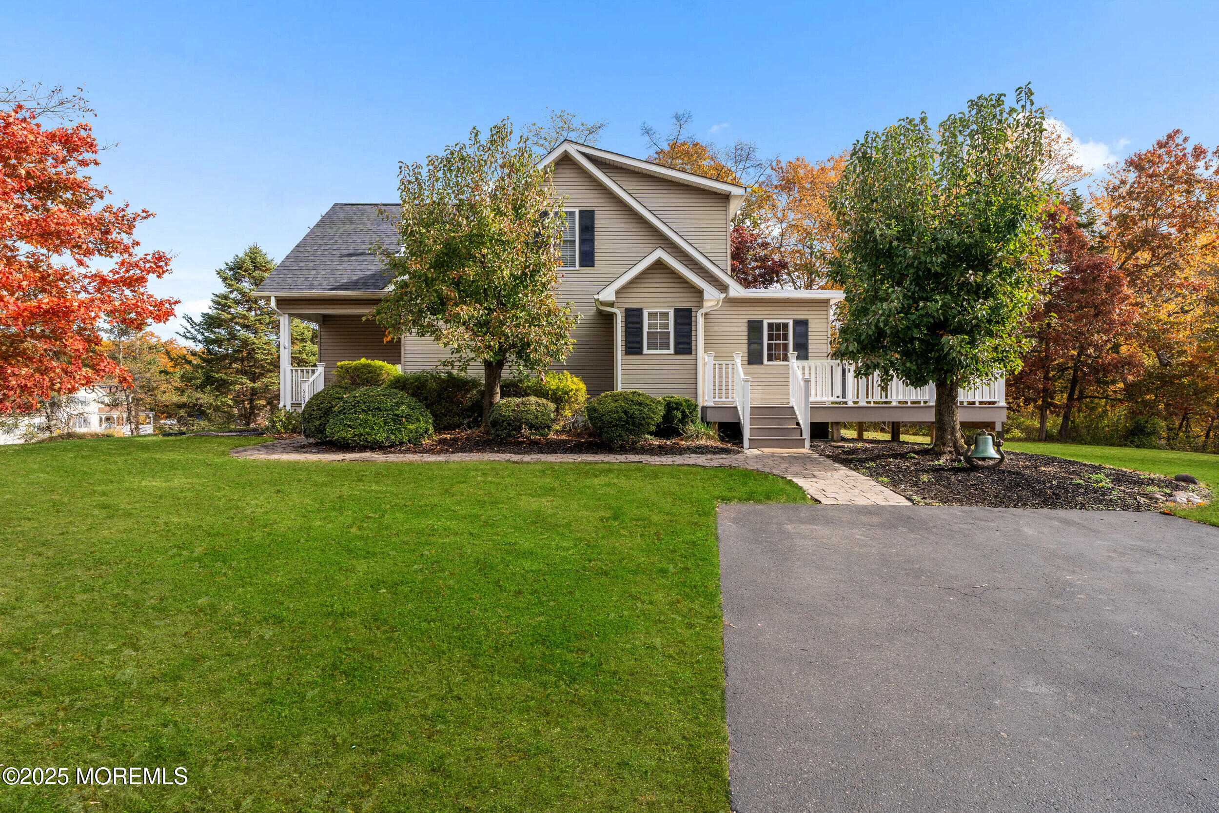 603 West Farms Road Howell, NJ 07731 - Photo 4 of 38 a front view of a house with a garden and trees