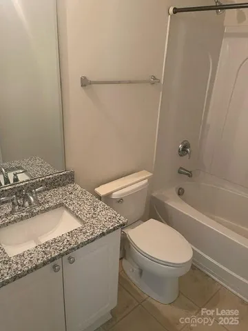 a white toilet sitting next to a bath tub