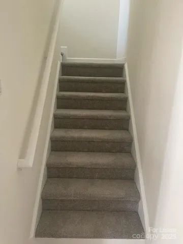 a view of staircase with white walls