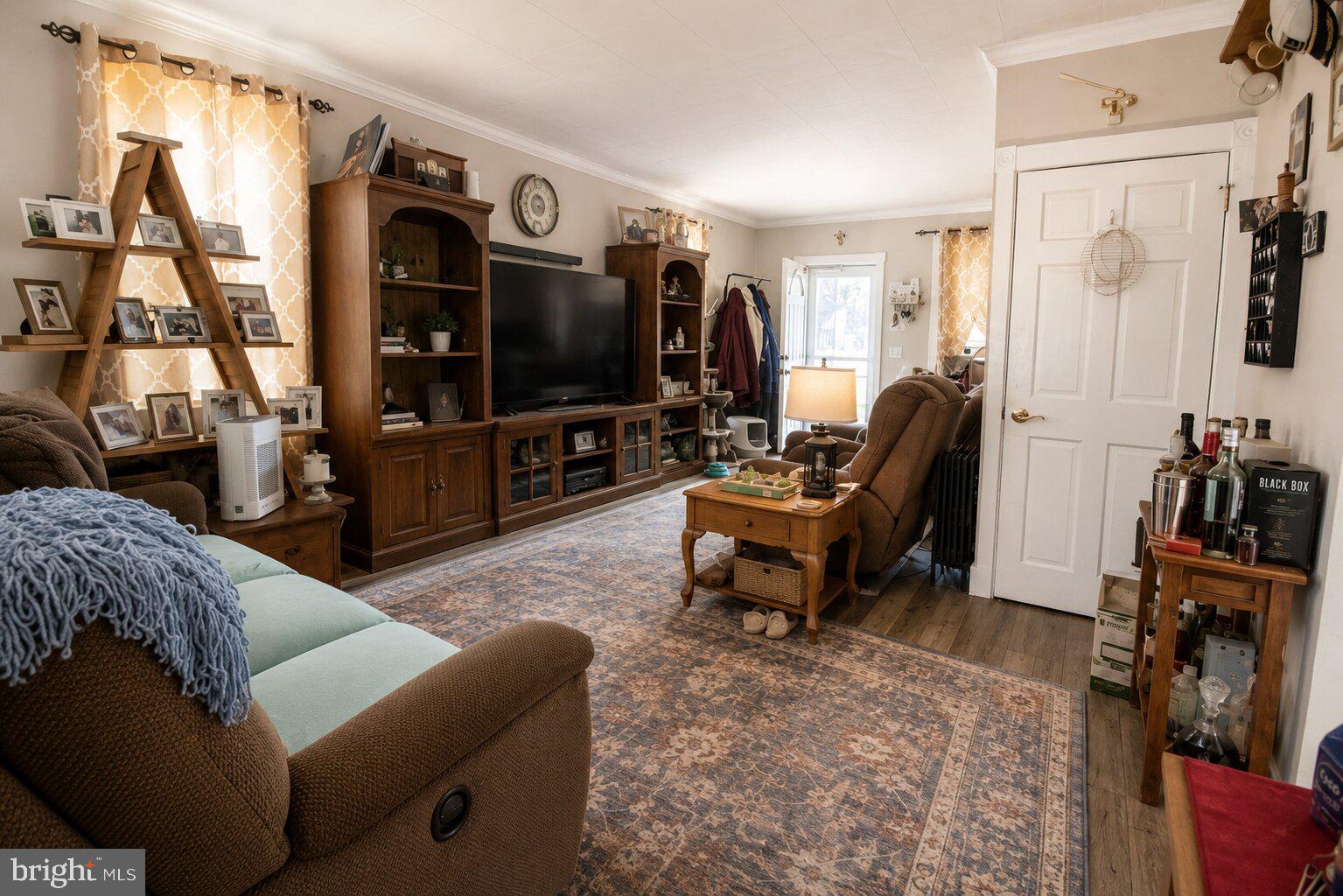 100 Grant Street Riverside, NJ 08075 - Photo 17 of 34 a living room with furniture a flat screen tv and a window