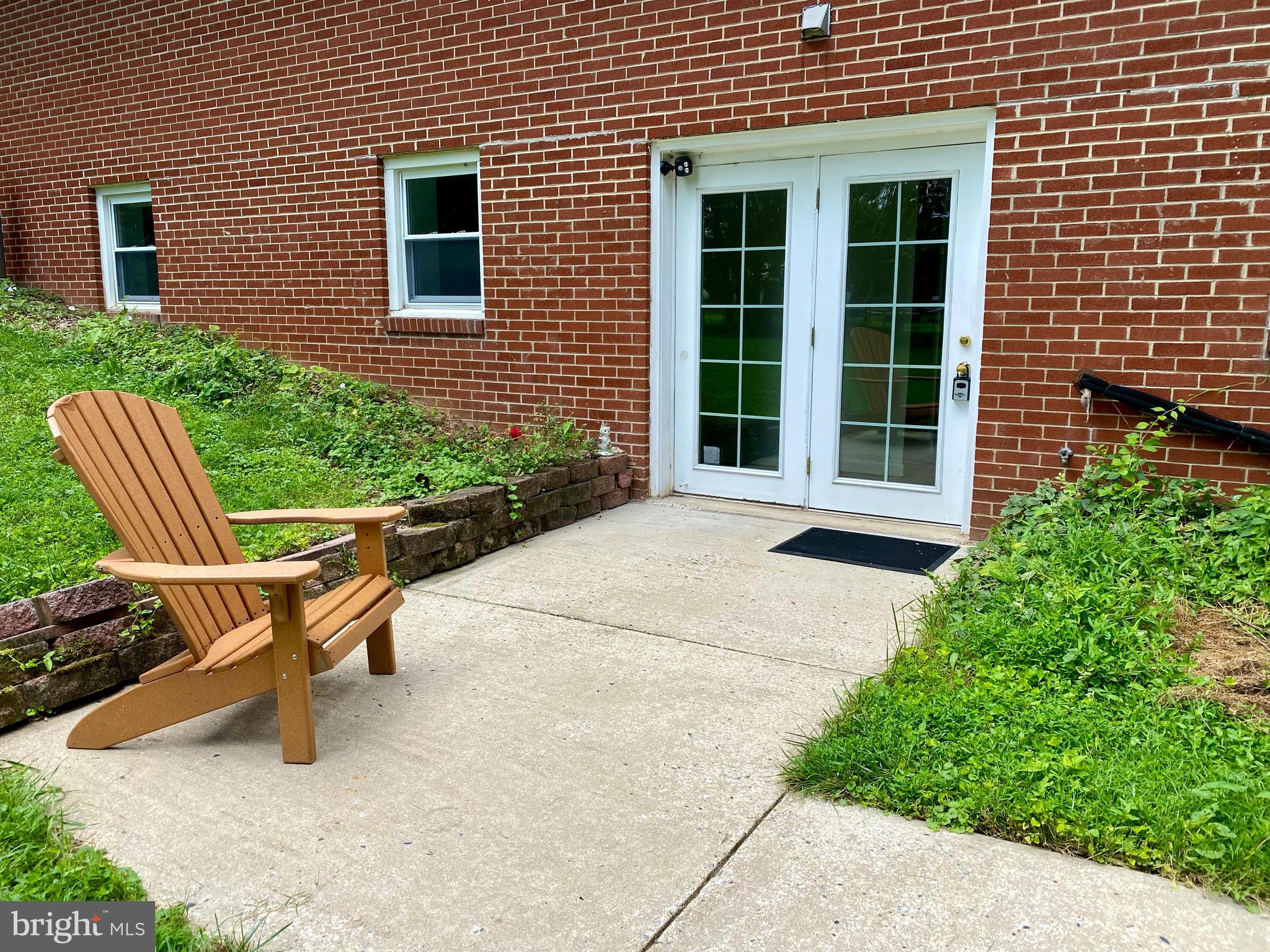 a view of a house with a yard and sitting area