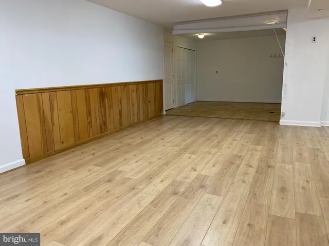 an empty room with wooden floor