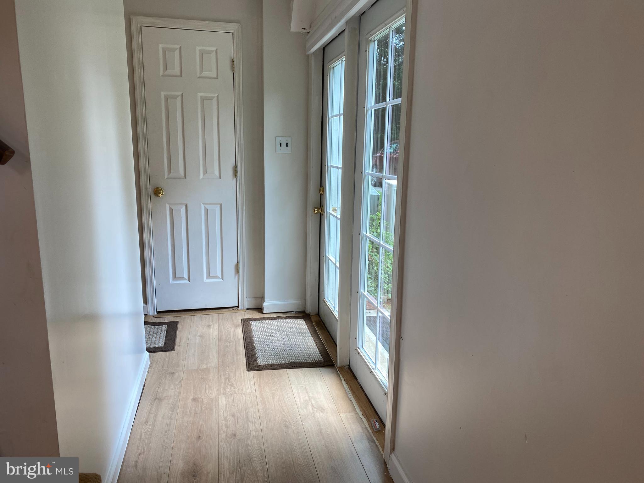 1851 Florence Road, Unit A Mount Airy, MD 21771 - Photo 5 of 19 a view of a hallway with wooden floor and a window