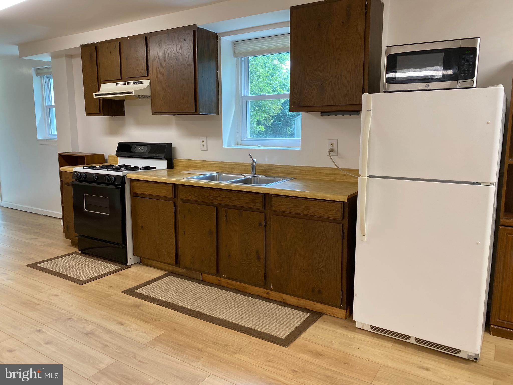 1851 Florence Road, Unit A Mount Airy, MD 21771 - Photo 7 of 19 a kitchen with stainless steel appliances granite countertop a refrigerator stove a sink dishwasher and microwave