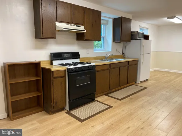 a kitchen with stainless steel appliances granite countertop a stove and a refrigerator