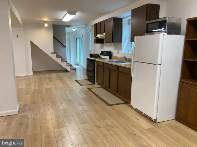 a kitchen with stainless steel appliances a refrigerator and a stove top oven