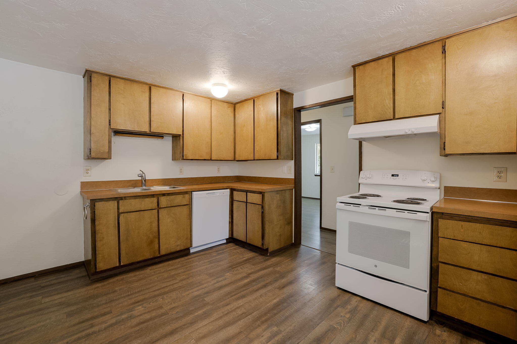 19968 Double Tree Court Bend, OR 97702 - Photo 12 of 28 a kitchen with a stove top oven sink and cabinets