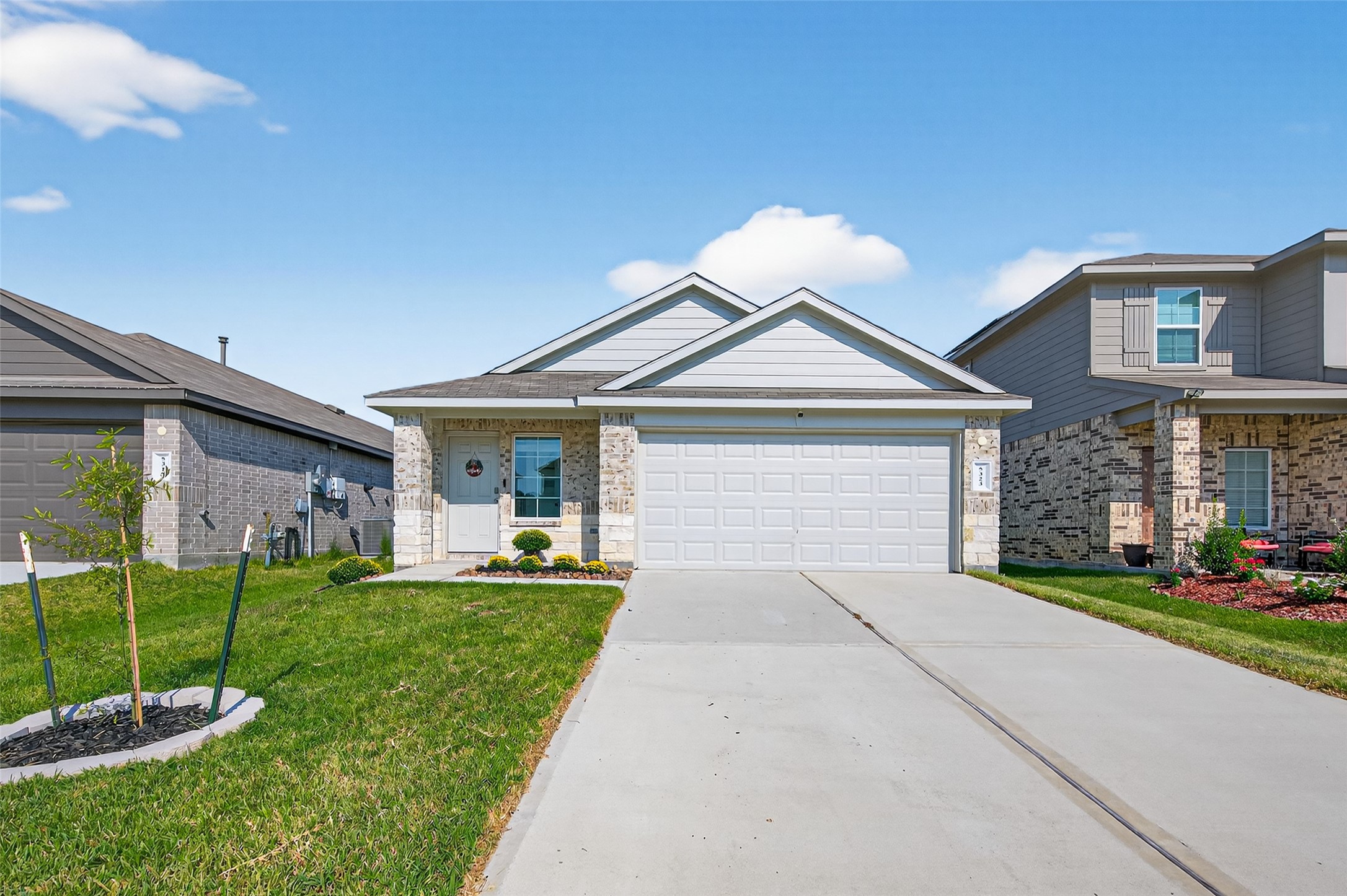a front view of a house with a yard and garage
