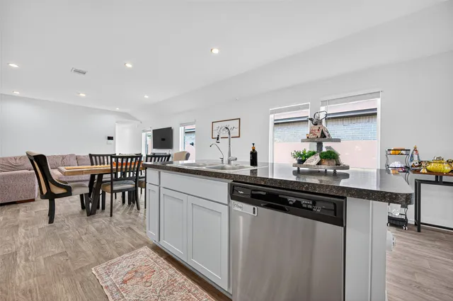 a kitchen with kitchen island granite countertop a sink and counter space