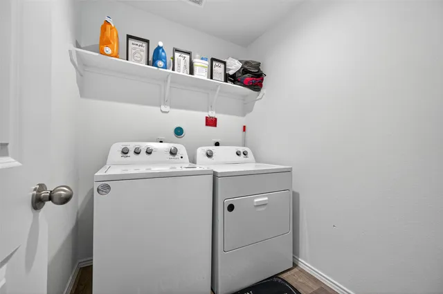 a bedroom with a bed wooden floor and window