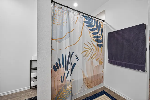 a bathroom with a sink a mirror and a shower