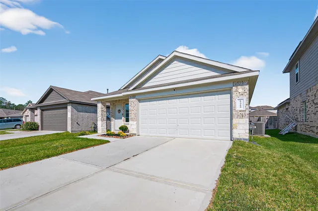 a front view of a house with a yard and garage