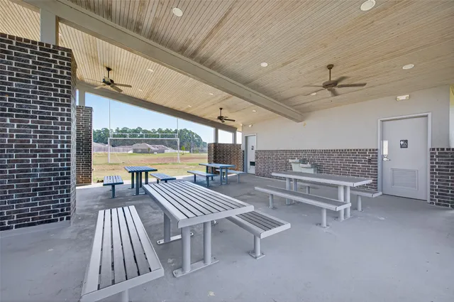 a roof deck with table and chairs