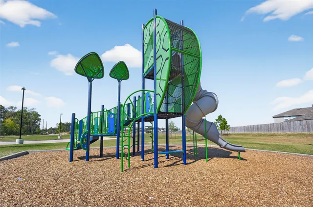 a view of a swimming pool with a patio and a yard