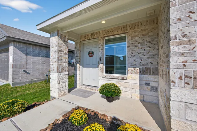 a view of a porch with a table and chairs