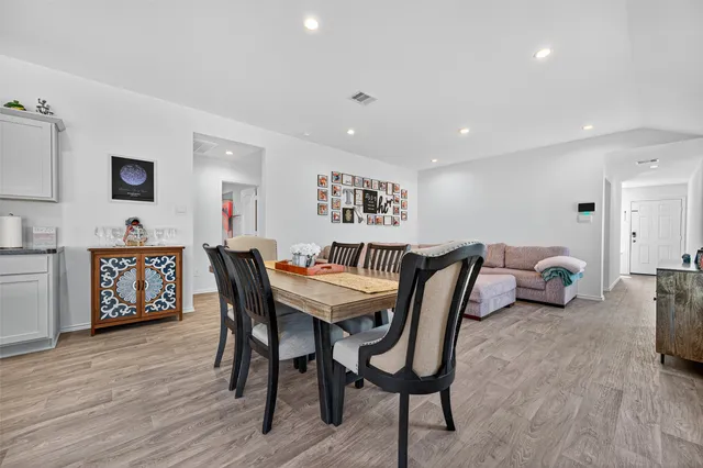 a view of a dining room with furniture and wooden floor