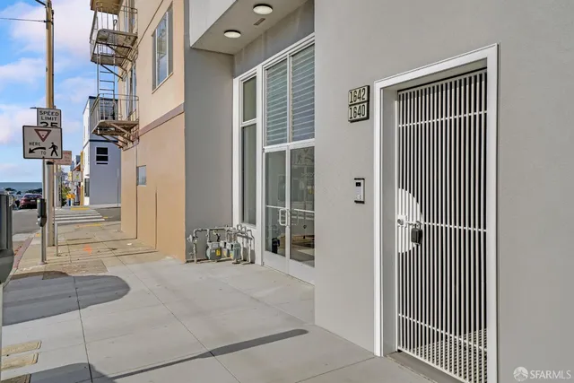 a kitchen with stainless steel appliances white cabinets and wooden floor