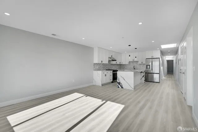 a view of wooden floor and windows in a room
