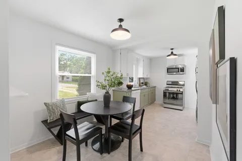 a kitchen with stainless steel appliances a stove a sink and a microwave
