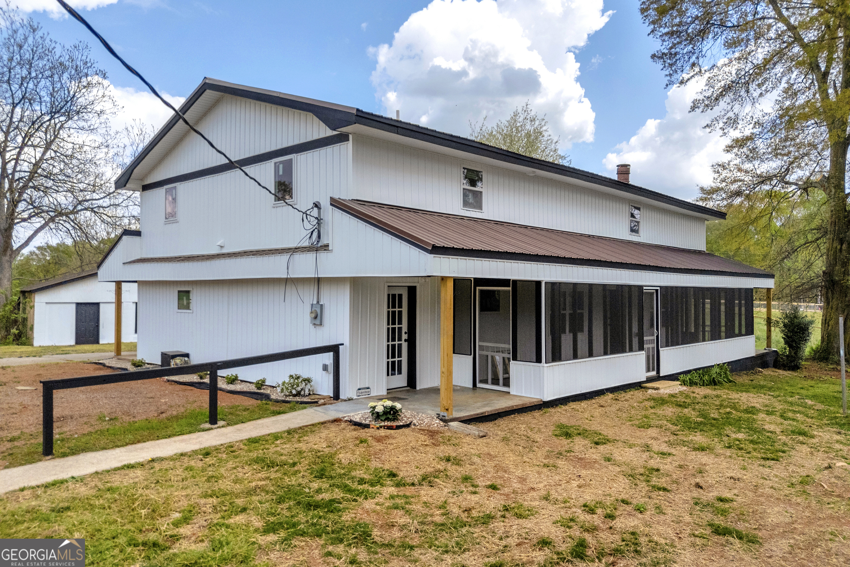 8606 Holly Springs Road Maysville, GA 30558 - Photo 13 of 74 a view of a house with wooden walls and a yard