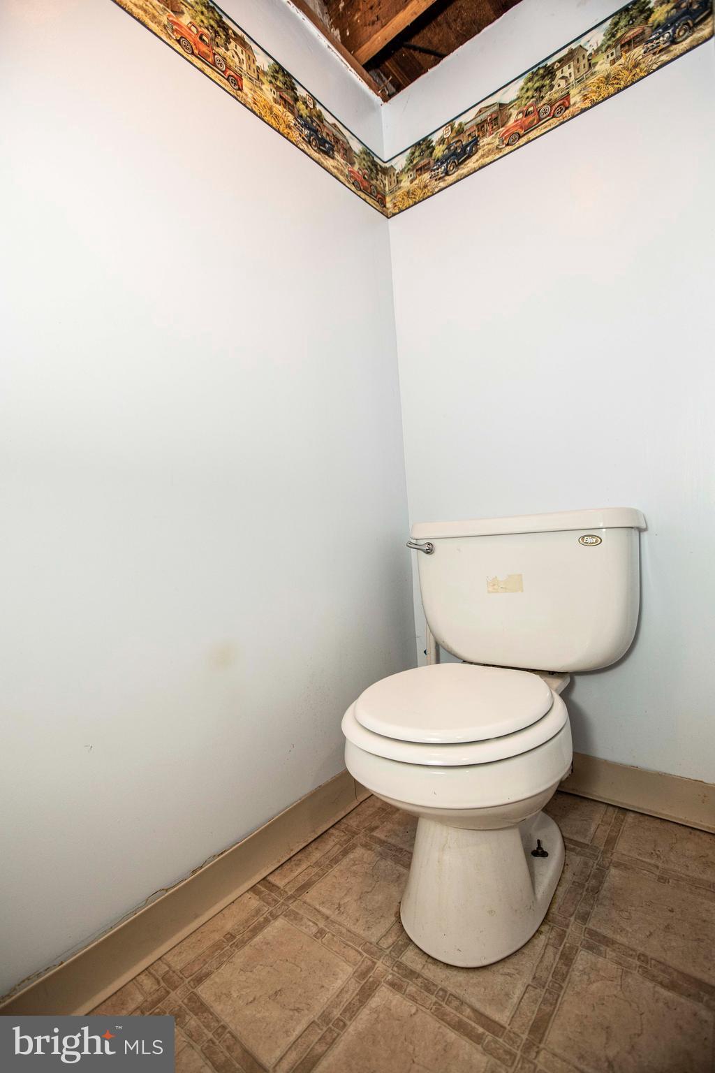 9 West Broad Street Reading, PA 19607 - Photo 14 of 27 Toilet in basement near laundry area.