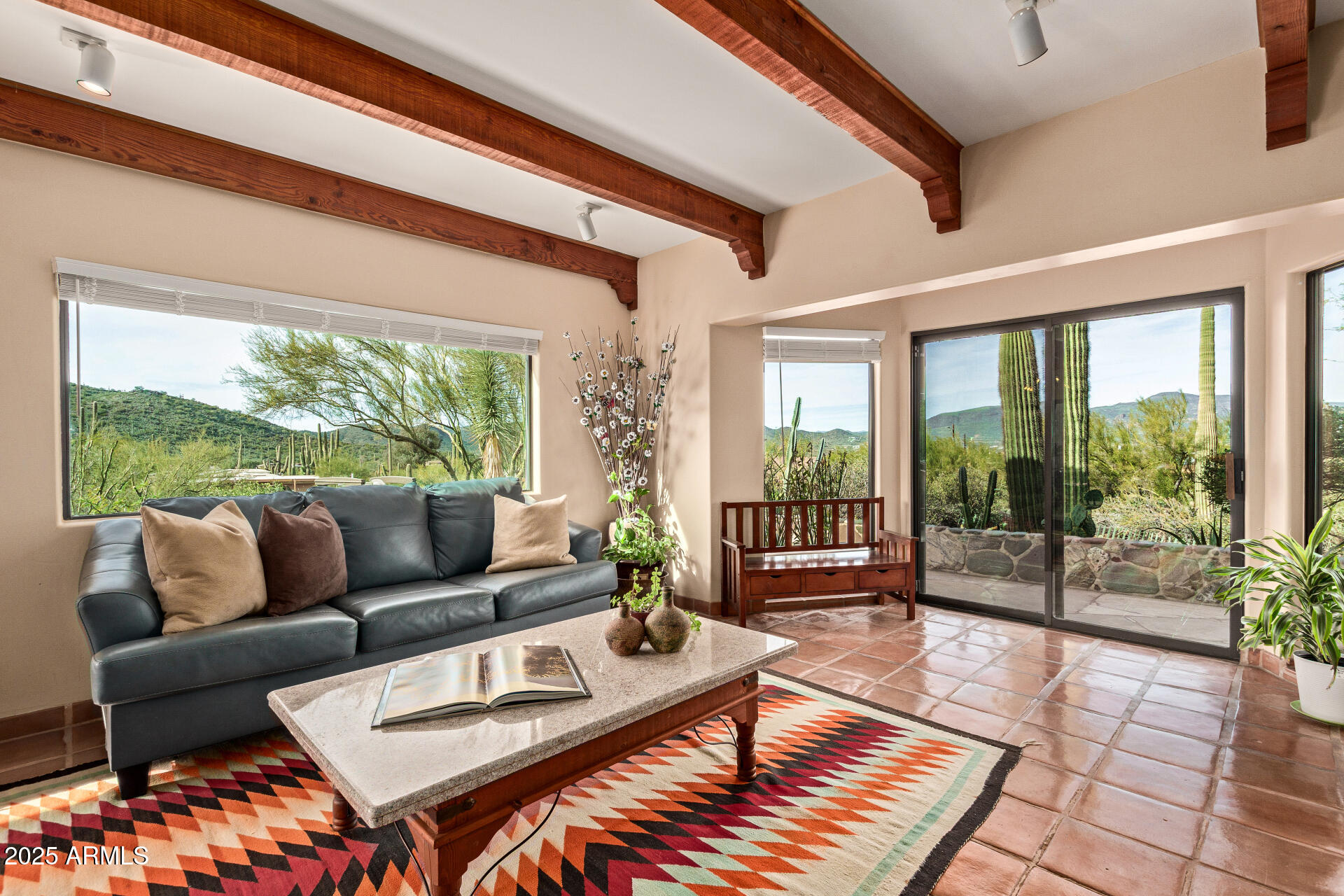 a living room with furniture and a floor to ceiling window