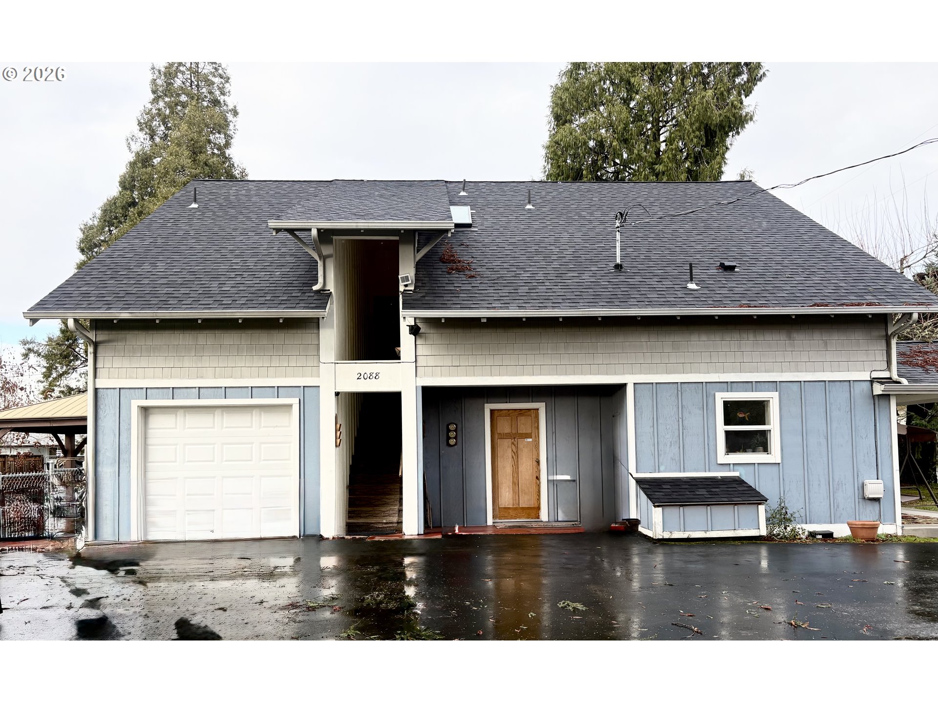 a view of a house with brick walls and floor to ceiling window