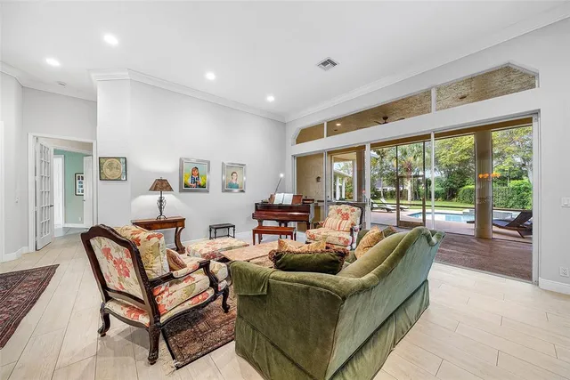 a dining room with furniture a chandelier and wooden floor