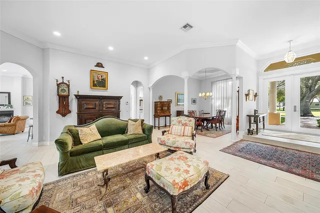 a living room with furniture a flat screen tv and a large window