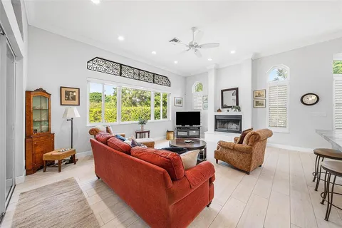 a dining hall with stainless steel appliances kitchen island a table and chairs