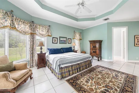 a view of hallway with windows and wooden floor