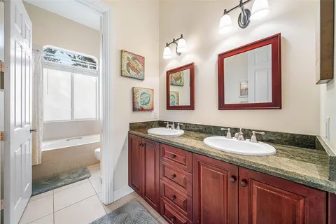 a view of hallway with windows and wooden floor