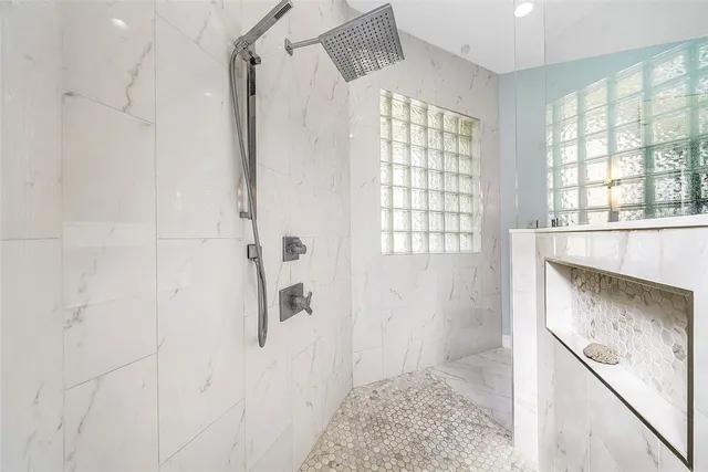 a bathroom with a granite countertop sink a toilet and shower