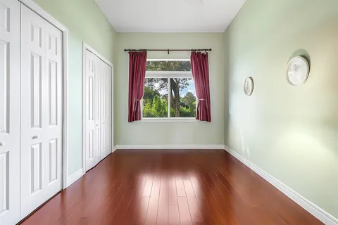 a bathroom with a toilet a sink a mirror a vanity and shower