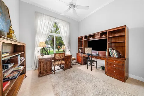 a view of swimming pool with couches chairs and wooden fence
