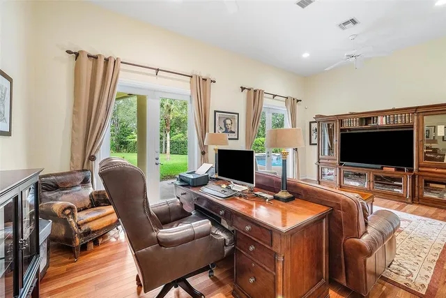 a view of a livingroom with furniture and floor to ceiling window