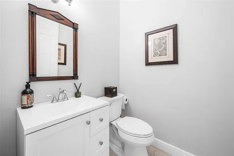 a front view of a house with a large garden and plants