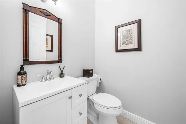 a front view of a house with a large garden and plants