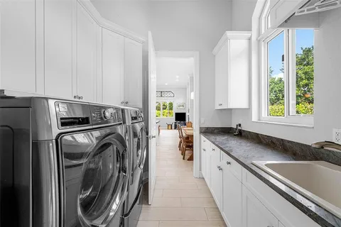 a view of pool with lawn chairs and large tree