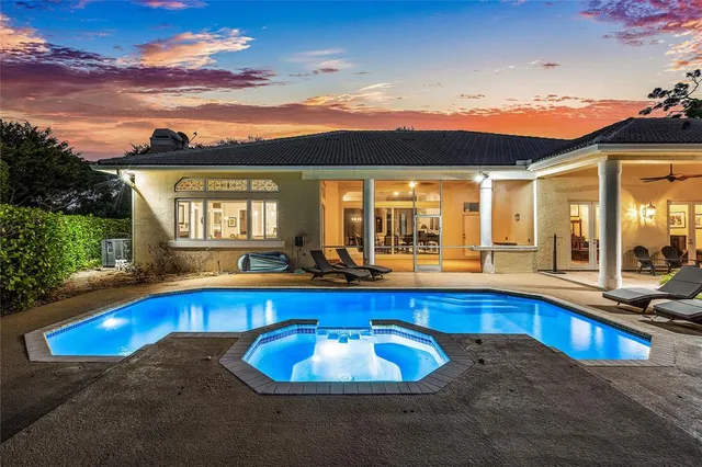 an aerial view of residential houses with outdoor space and trees