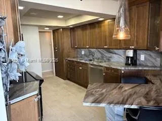 a kitchen with stainless steel appliances granite countertop a refrigerator and a stove