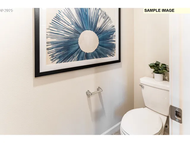 a bathroom with a toilet and a chair