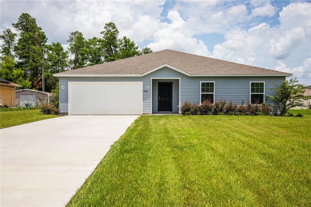 a front view of house with yard and green space