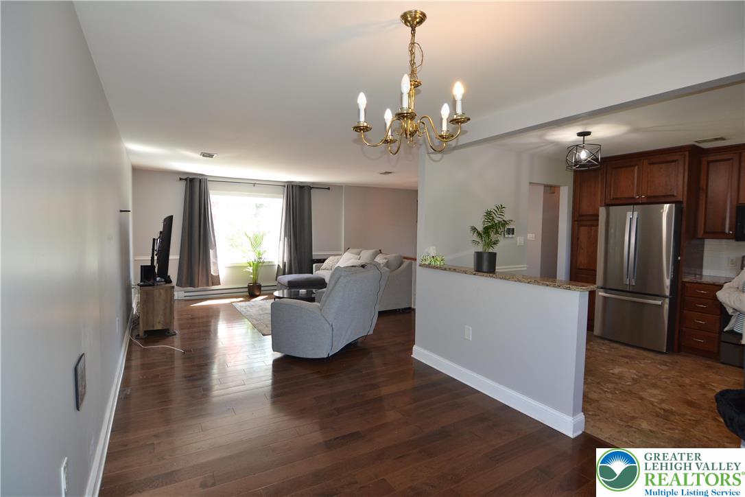 3071 Athena Drive Bethlehem, PA 18017 - Photo 12 of 27 a living room with furniture or kitchen and a chandelier