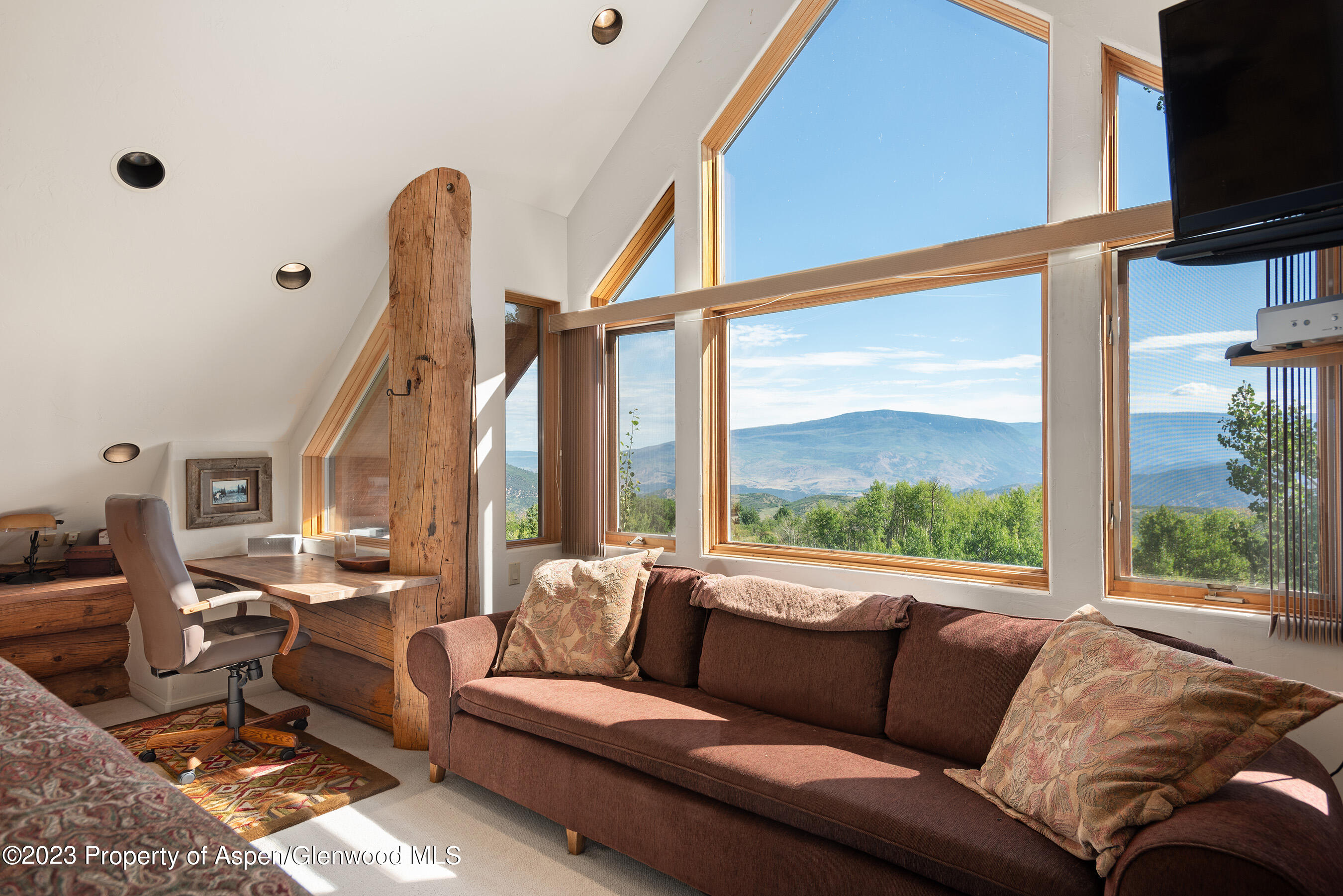 4275 Sopris Mountain Ranch Road Basalt, CO 81621 - Photo 14 of 36 a living room with furniture and a flat screen tv