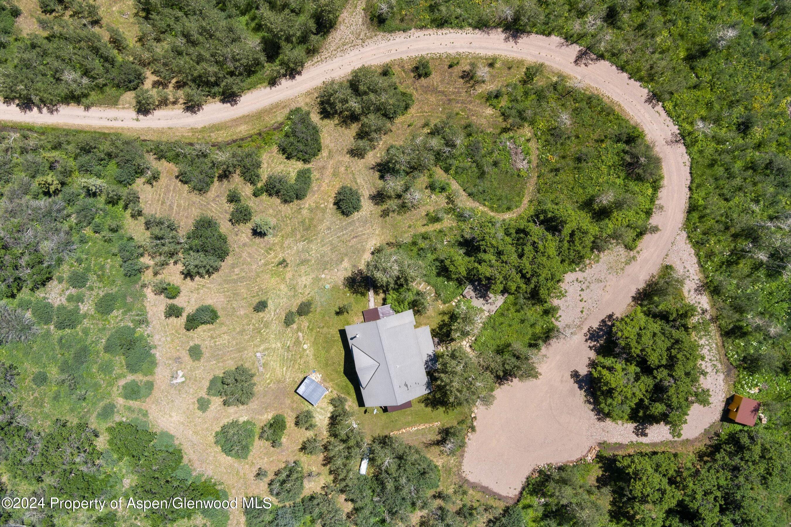 4275 Sopris Mountain Ranch Road Basalt, CO 81621 - Photo 24 of 36 an aerial view of a house with a yard
