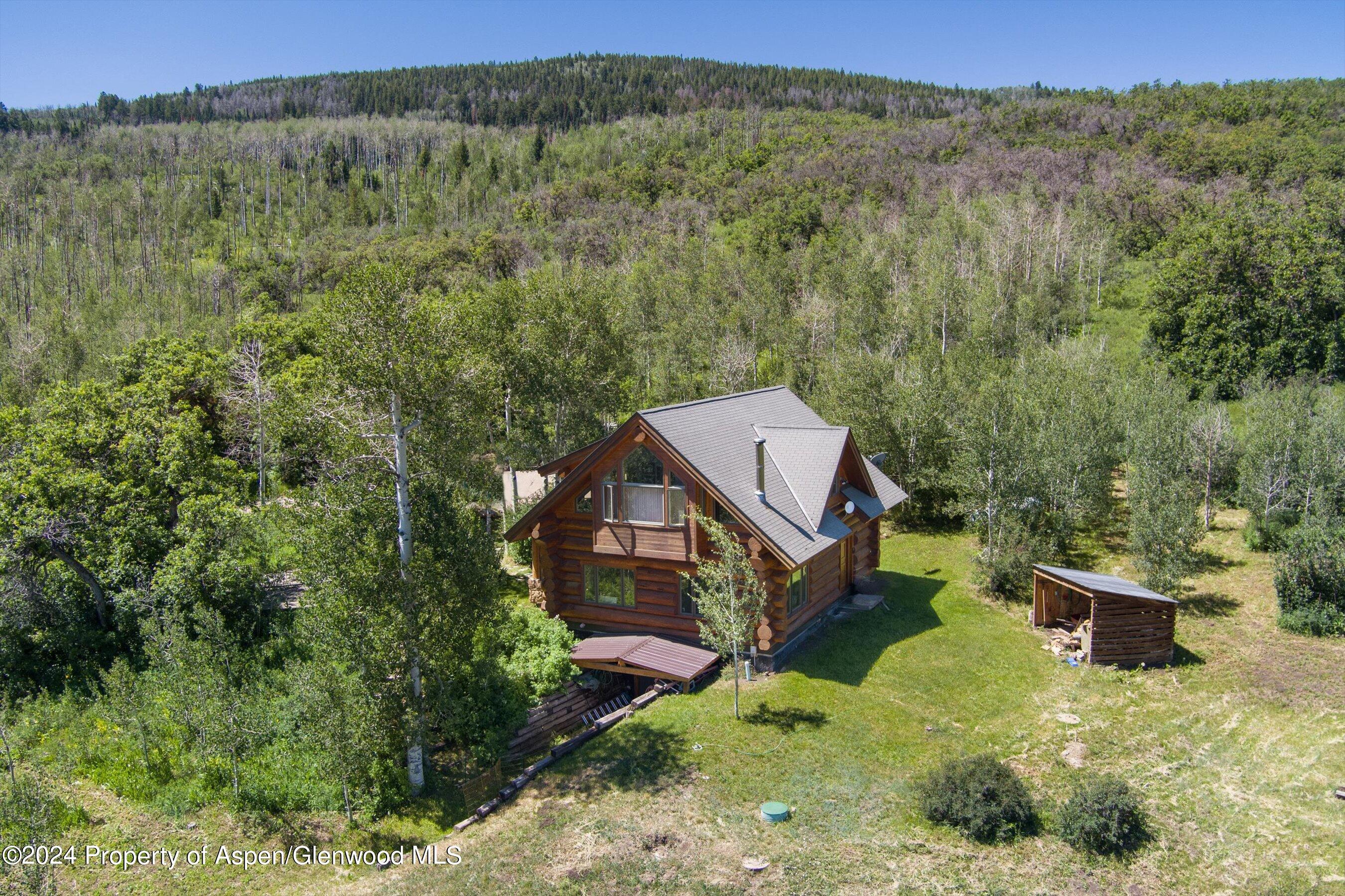 4275 Sopris Mountain Ranch Road Basalt, CO 81621 - Photo 27 of 36 an aerial view of a house with a yard